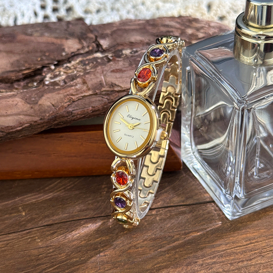 Oval watch with gemstones and diamonds